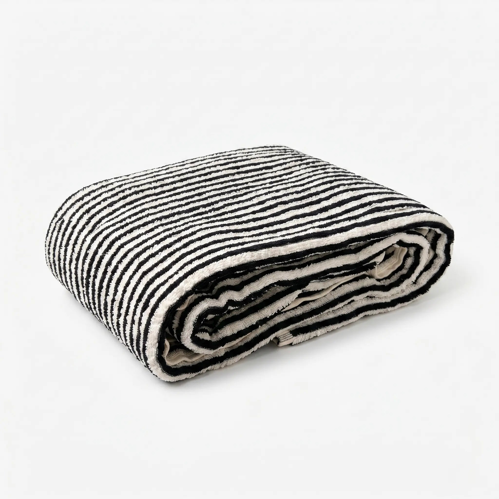 Folded black and white striped bath towel on a white background