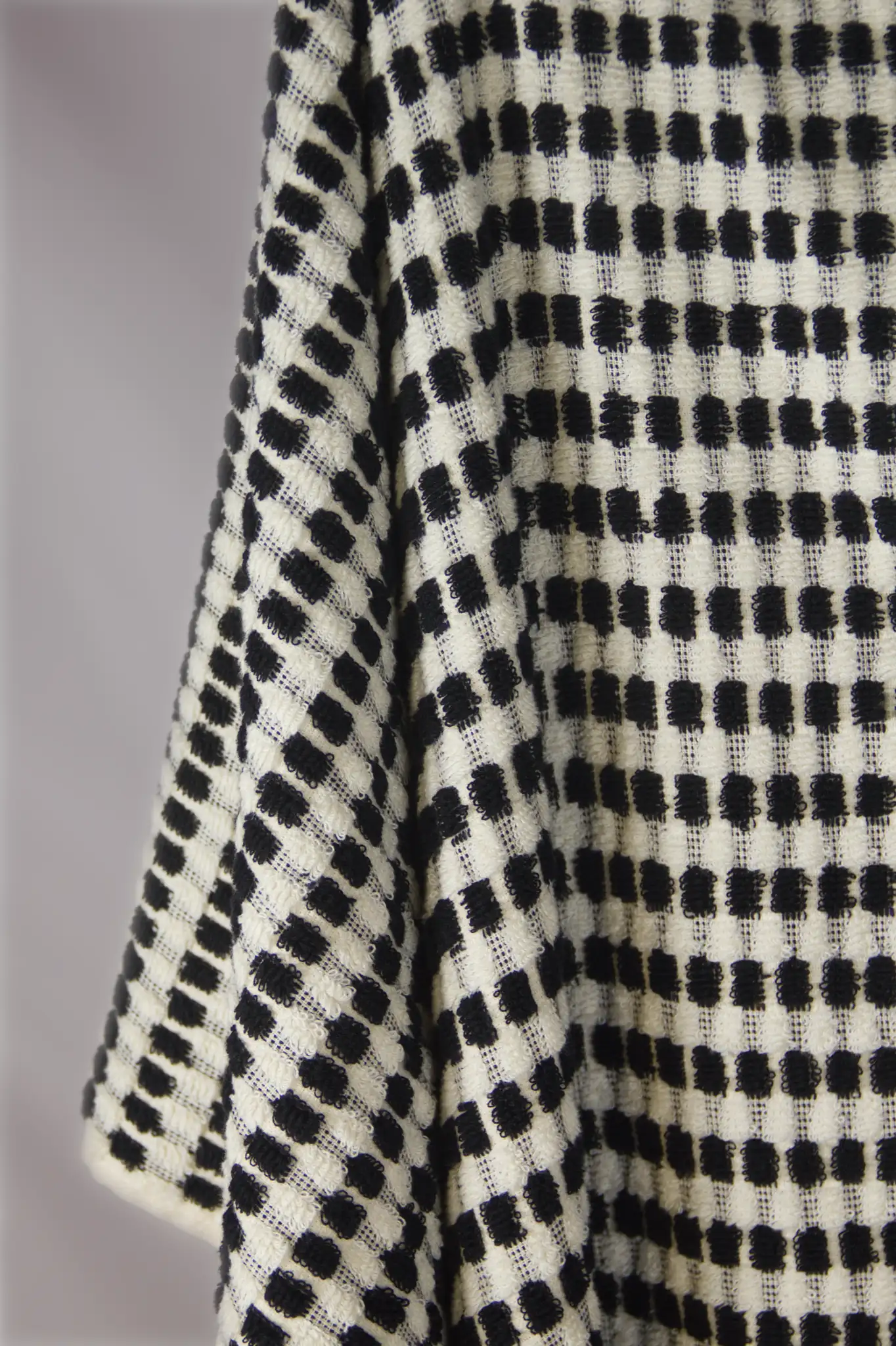 Close-up of a black and white checkered bath towel texture.
